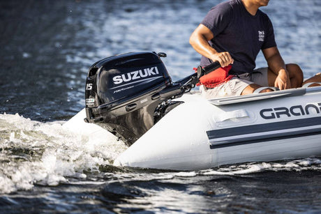 Suzuki 15 HP Black Tiller in Use On Dinghy Side View